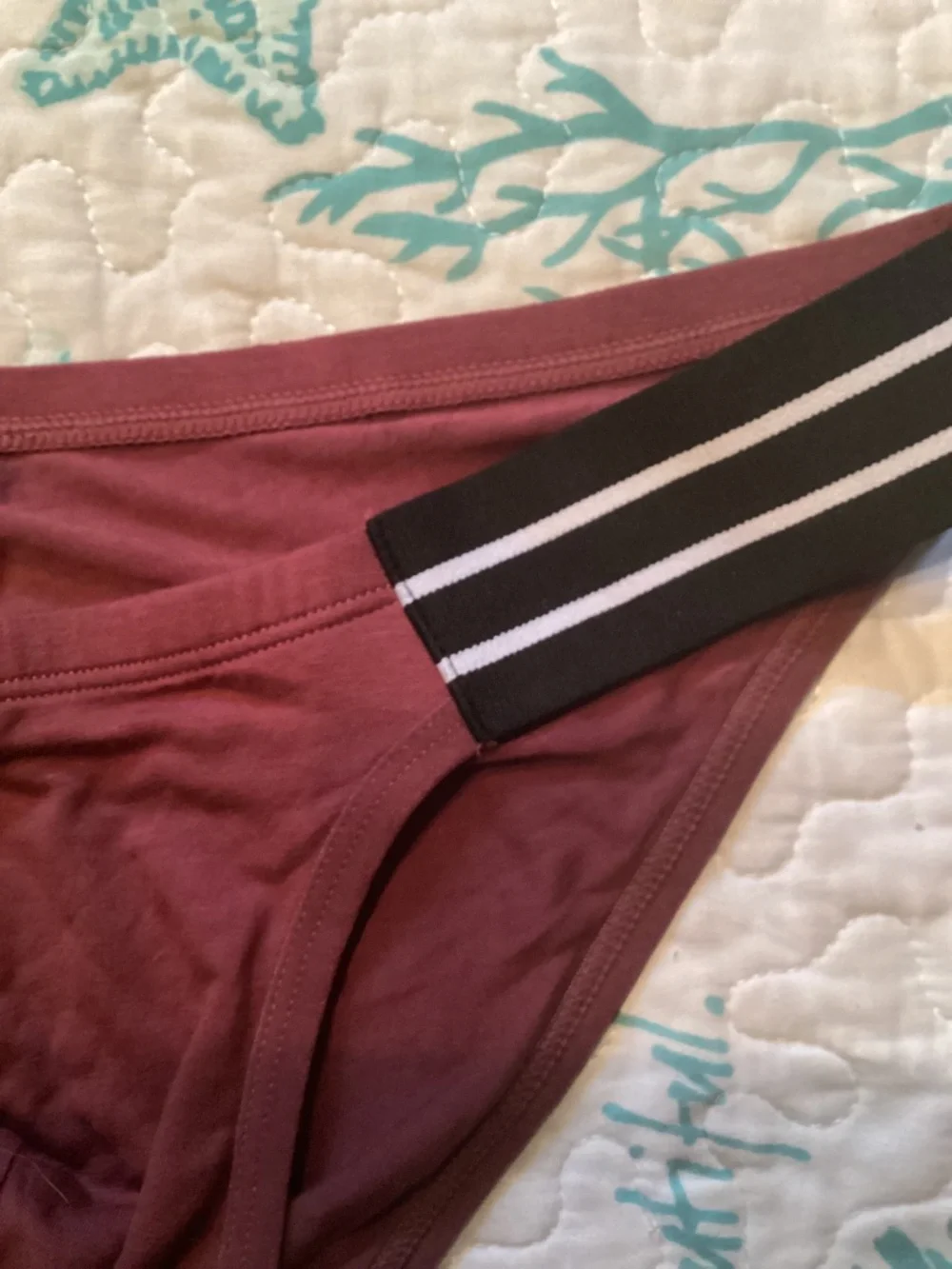 Sexy, burgendy color brief with black side straps.